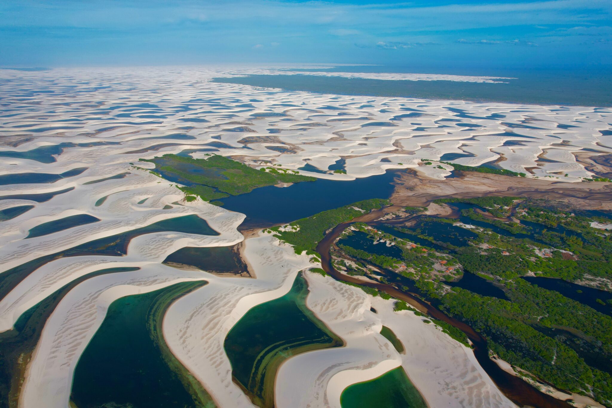 Vista aérea dos Lençóis Maranhenses entrecortados pelo rio